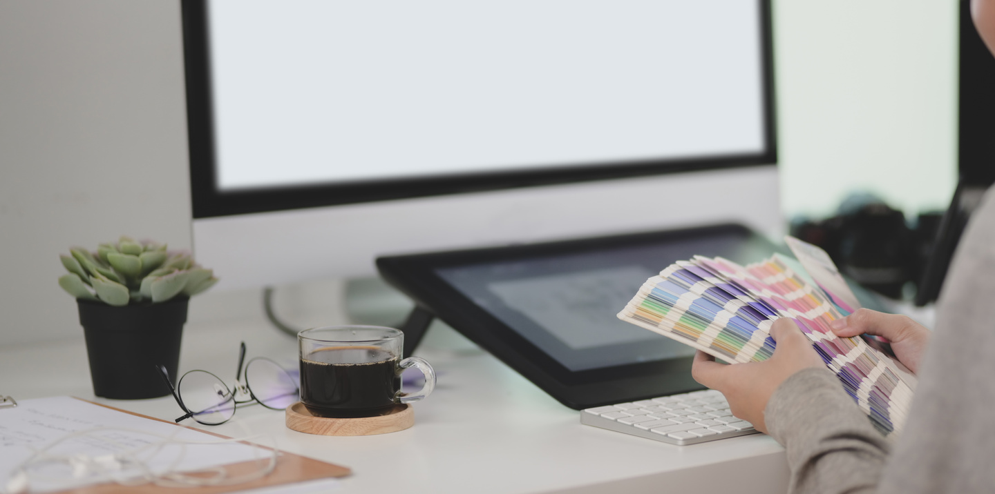 Crop artist with color samples during workday in modern office