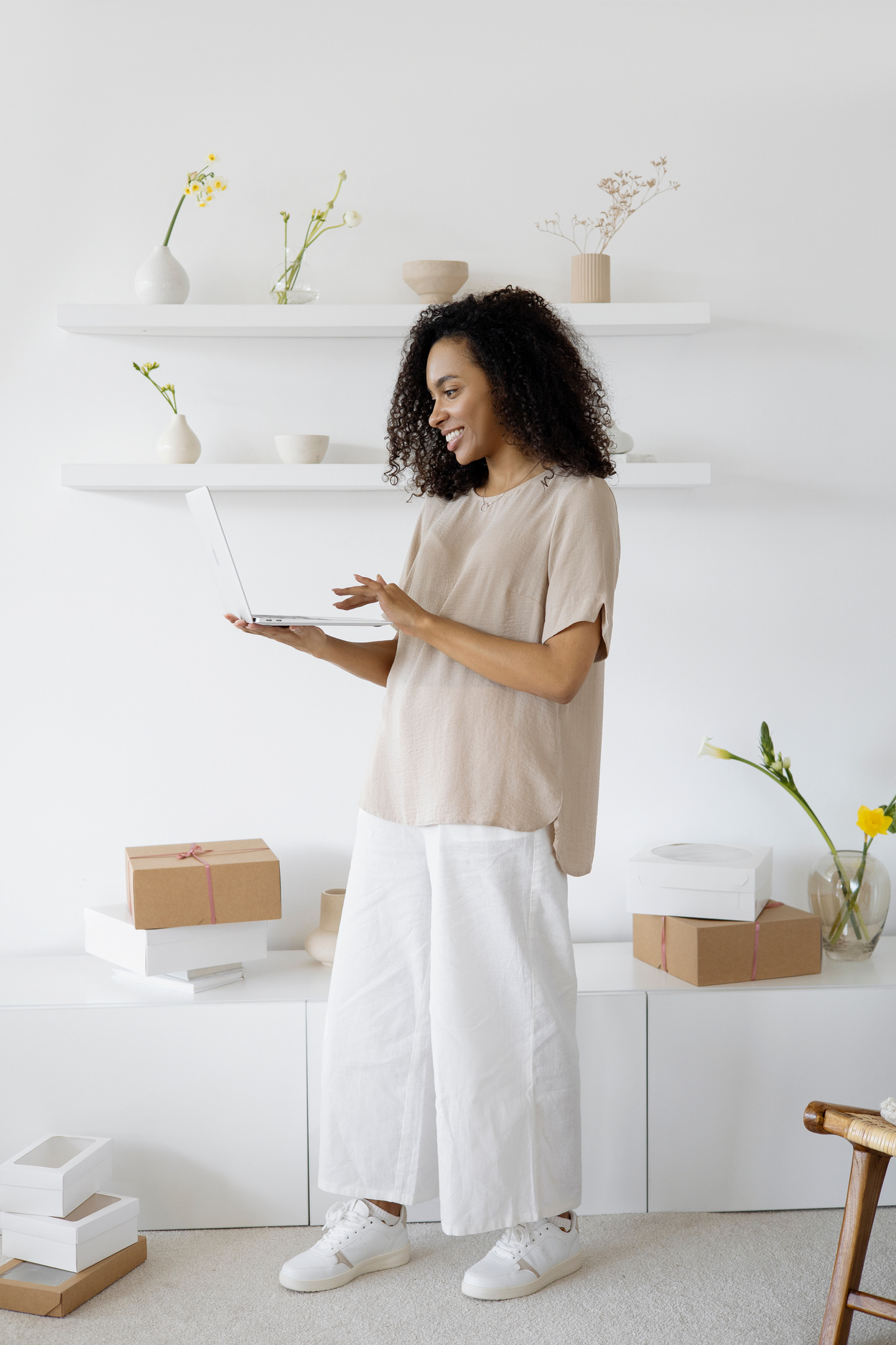 A Woman Smiling while Using Her Laptop